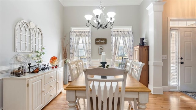 dining room featuring a notable chandelier and light wood-type flooring