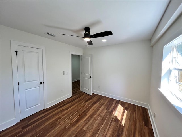 unfurnished bedroom featuring recessed lighting, visible vents, a ceiling fan, baseboards, and dark wood-style flooring