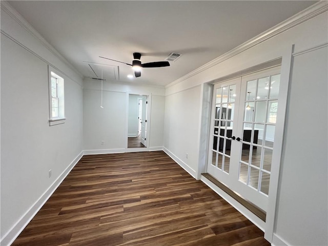empty room featuring wood finished floors, visible vents, french doors, baseboards, and attic access
