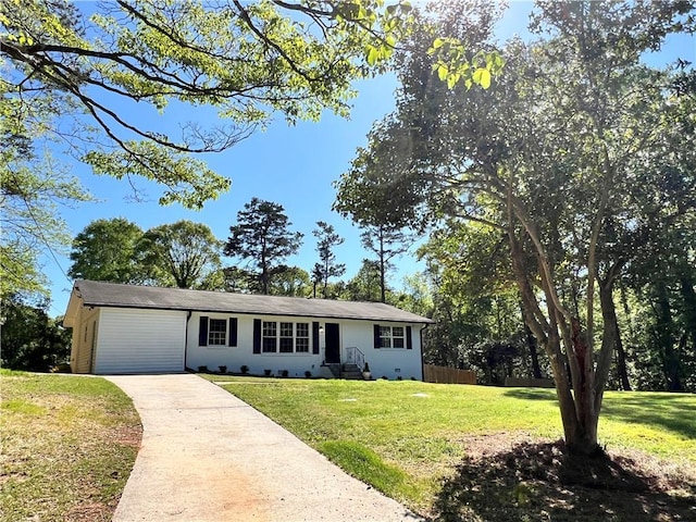 ranch-style house with driveway and a front lawn