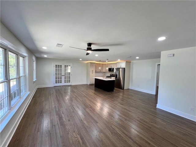 unfurnished living room with baseboards, french doors, visible vents, and recessed lighting