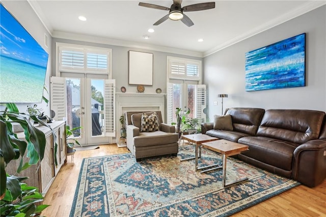 living room featuring french doors, ceiling fan, ornamental molding, and light hardwood / wood-style flooring