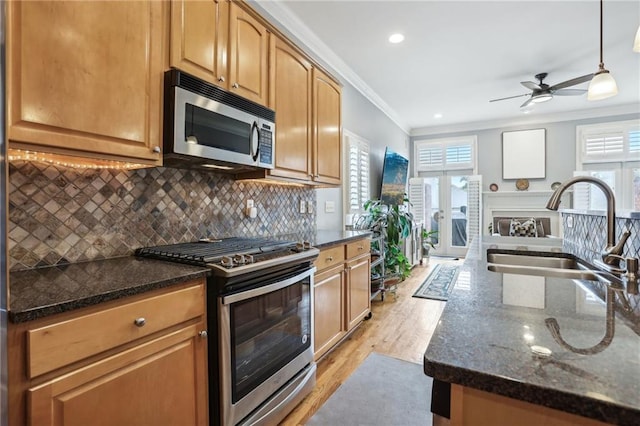 kitchen featuring light hardwood / wood-style floors, a healthy amount of sunlight, appliances with stainless steel finishes, and sink