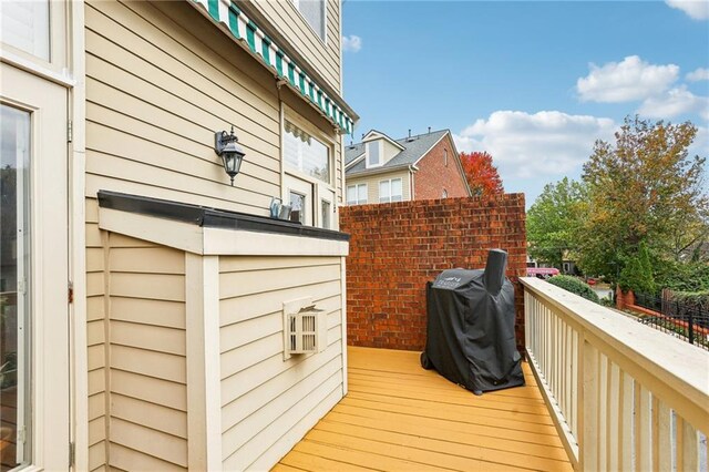 wooden deck with a grill