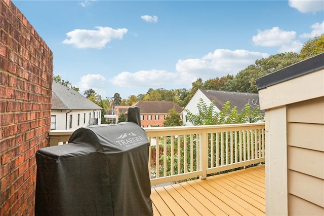 wooden terrace with a grill