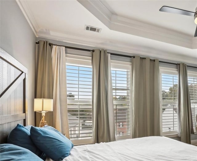 bedroom with ornamental molding, multiple windows, and ceiling fan