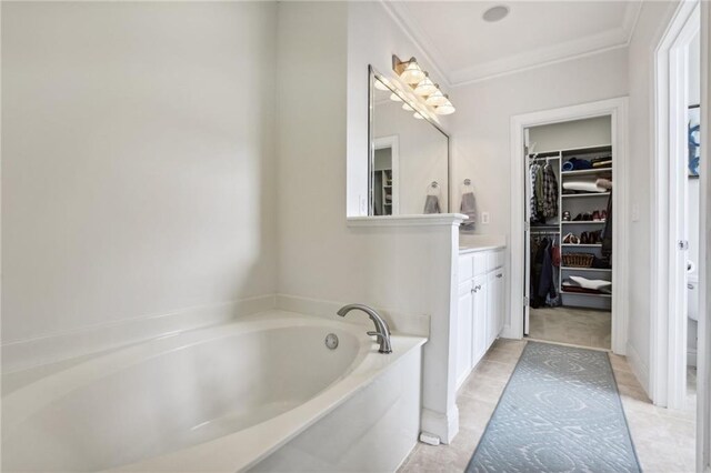 bathroom with vanity, a tub to relax in, crown molding, and tile patterned flooring