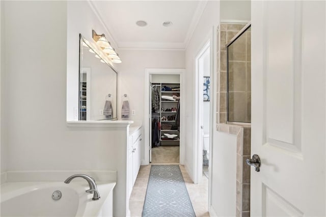 bathroom featuring vanity, ornamental molding, shower with separate bathtub, and tile patterned floors