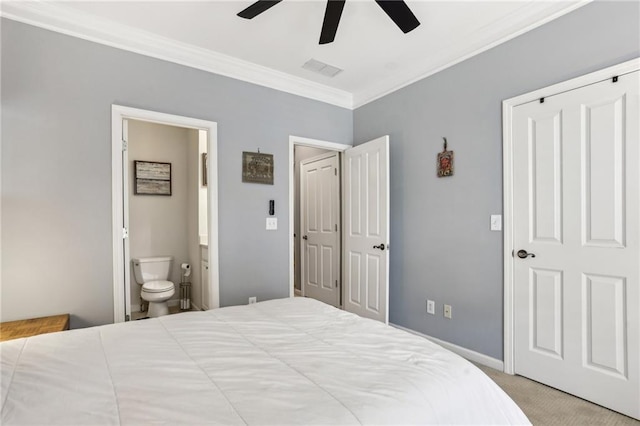 carpeted bedroom featuring crown molding, ensuite bathroom, and ceiling fan