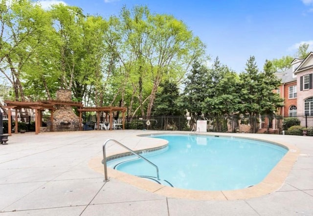 view of swimming pool with a patio and a pergola