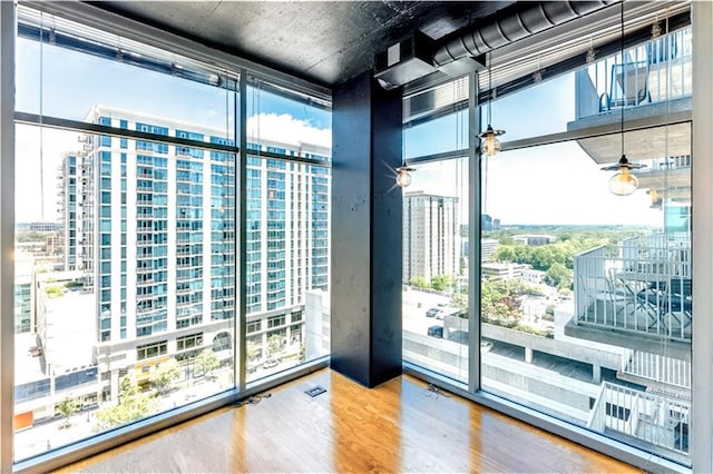 doorway to outside featuring wood-type flooring and expansive windows