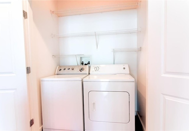 clothes washing area featuring washing machine and clothes dryer