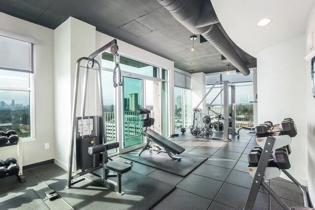 exercise area featuring a paneled ceiling and light hardwood / wood-style floors