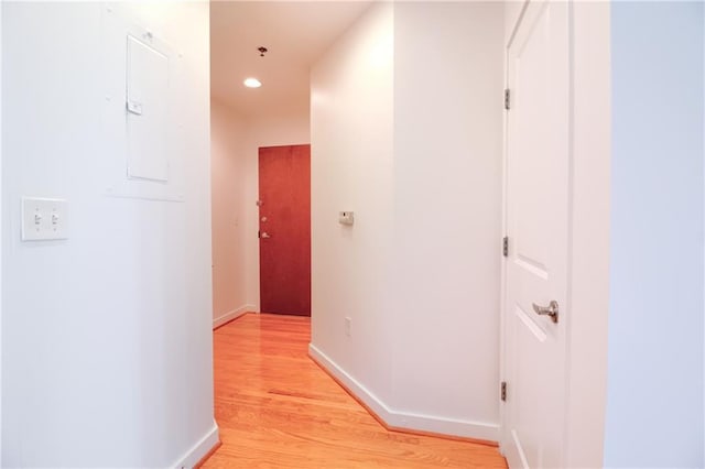 corridor with light hardwood / wood-style floors