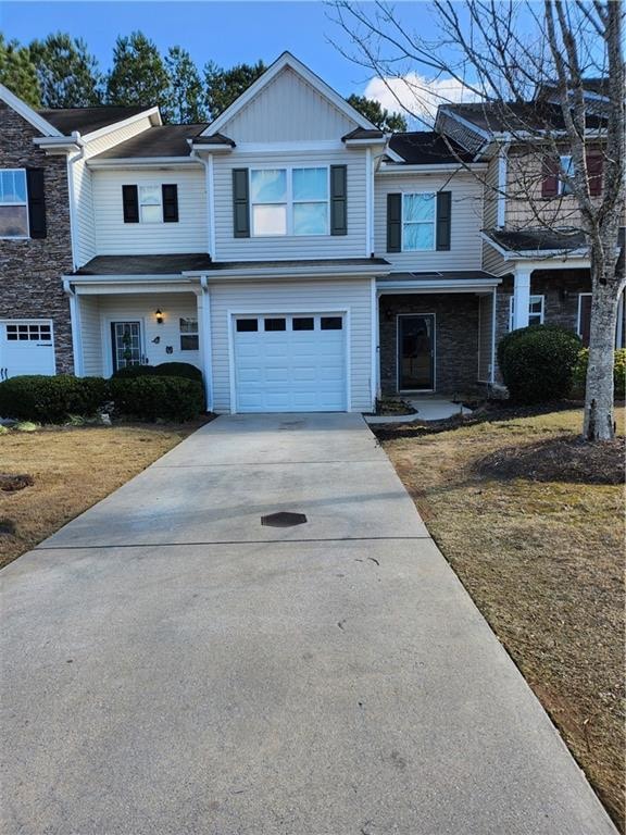 view of front of home with a front yard and a garage