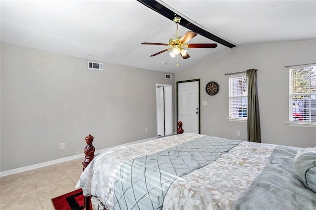 bedroom with visible vents, vaulted ceiling with beams, baseboards, and tile patterned floors