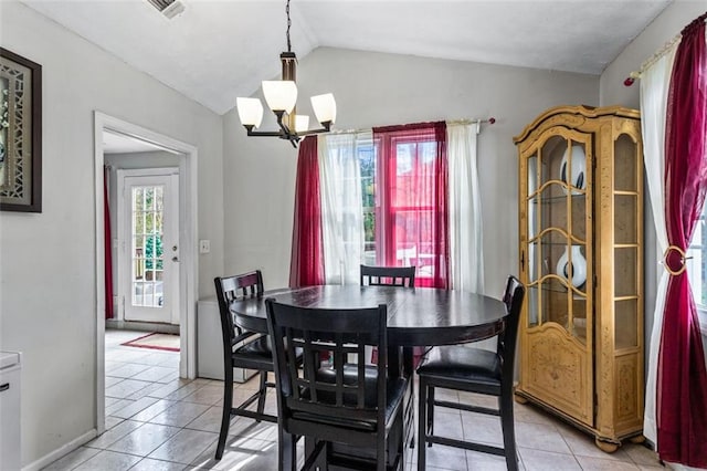 dining room with lofted ceiling, visible vents, an inviting chandelier, light tile patterned flooring, and baseboards