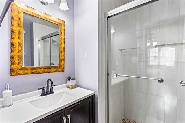 full bathroom featuring a stall shower and vanity