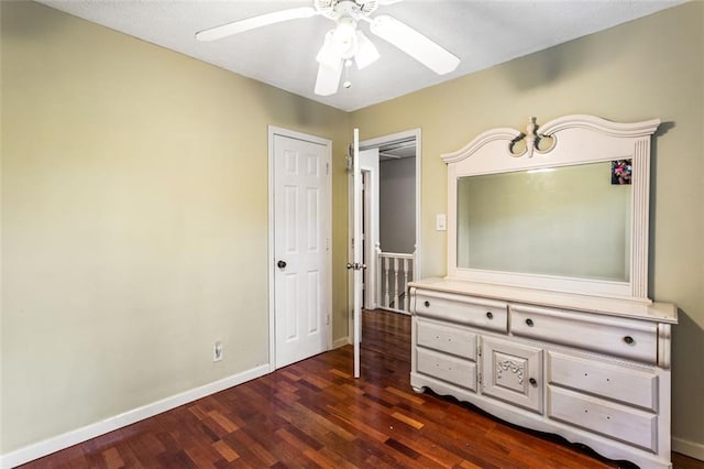 bedroom featuring dark wood-style floors, baseboards, and a ceiling fan