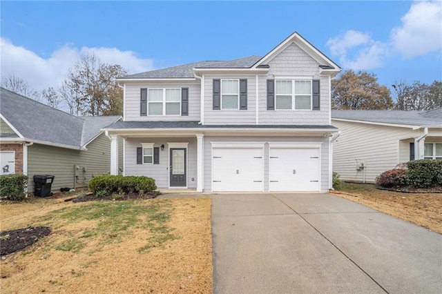 view of front of property with a garage and a front lawn