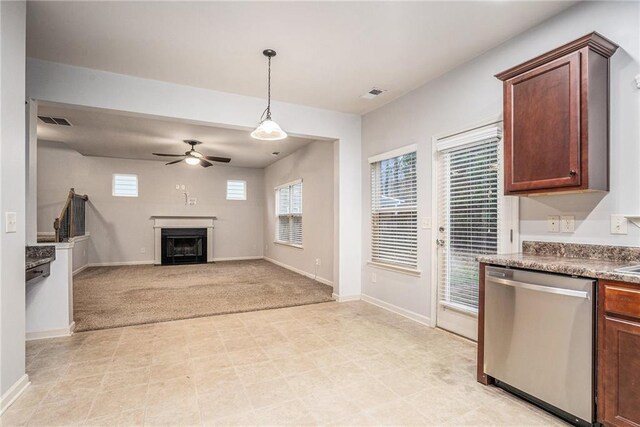 kitchen with ceiling fan, dishwasher, light colored carpet, and decorative light fixtures