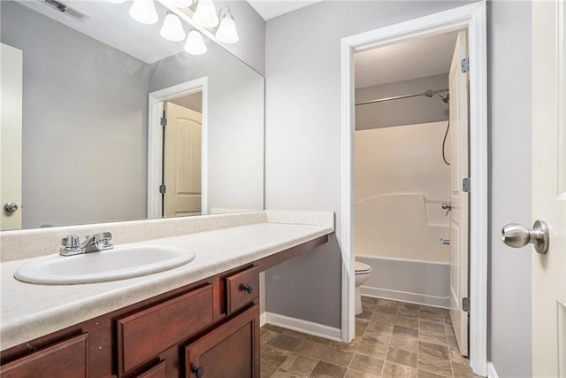 full bathroom featuring vanity, tub / shower combination, a notable chandelier, and toilet