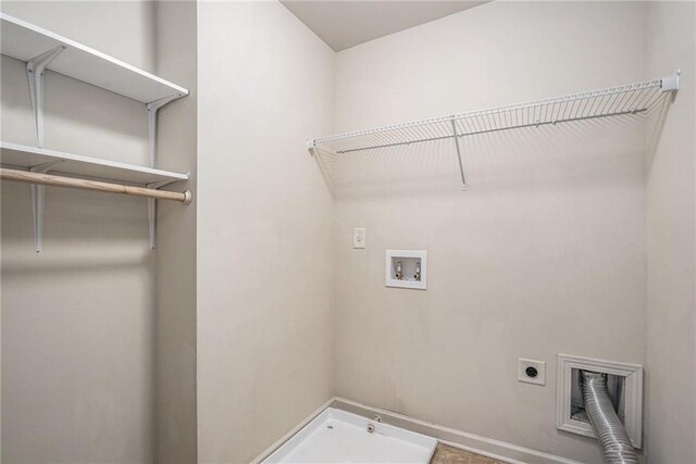 clothes washing area featuring hookup for an electric dryer and hookup for a washing machine