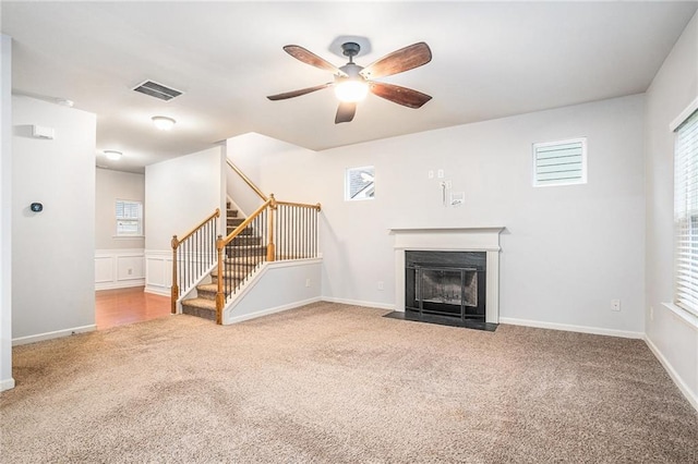 unfurnished living room with carpet flooring and ceiling fan