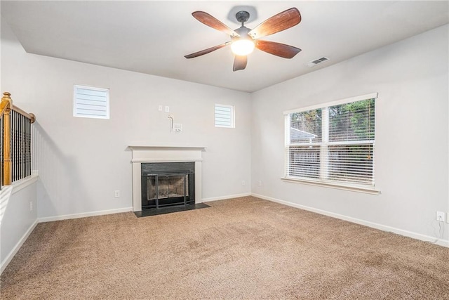 unfurnished living room with carpet and ceiling fan