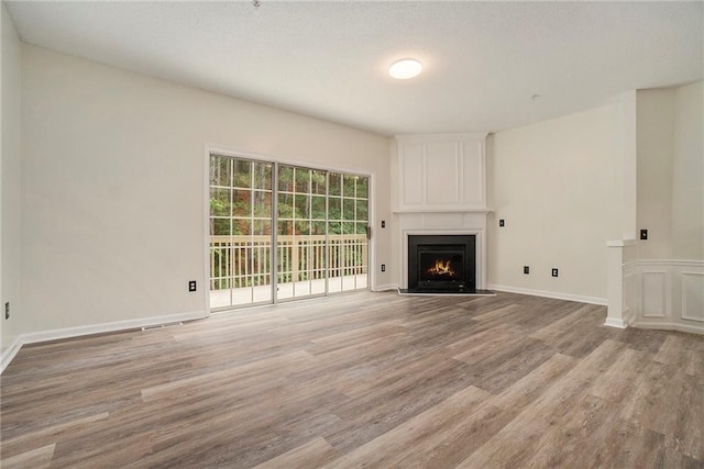 234 Riverstone Commons Cir, Canton, GA 30114 - unfurnished living room with light wood-style flooring and a large fireplace