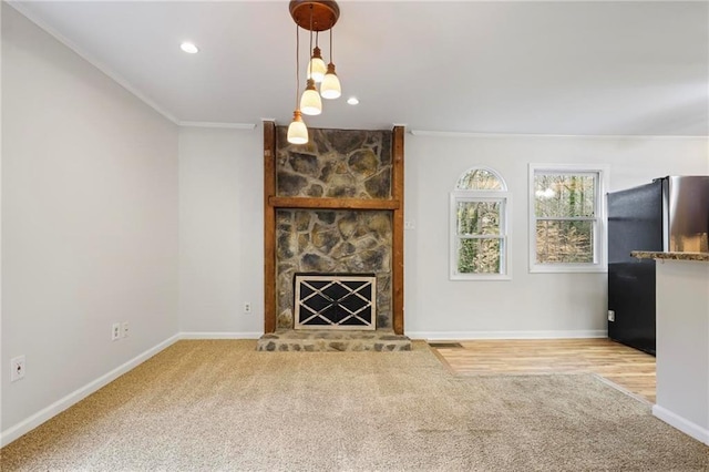 unfurnished living room with crown molding, carpet, and baseboards