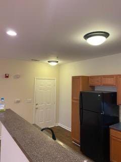 kitchen with black refrigerator