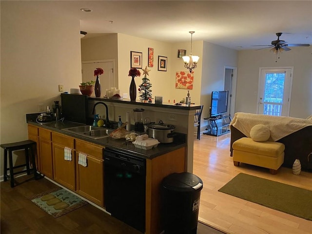 kitchen with ceiling fan with notable chandelier, sink, decorative light fixtures, dishwasher, and light hardwood / wood-style floors