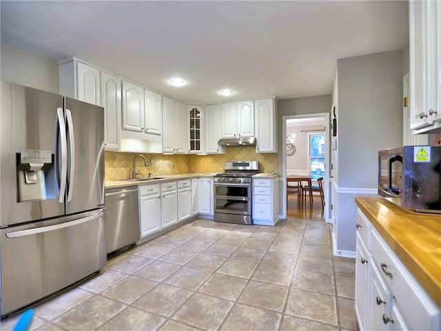 1257 Independence Way, Marietta, GA 30062 - kitchen featuring stainless steel appliances, under cabinet range hood, a sink, decorative backsplash, and white cabinetry
