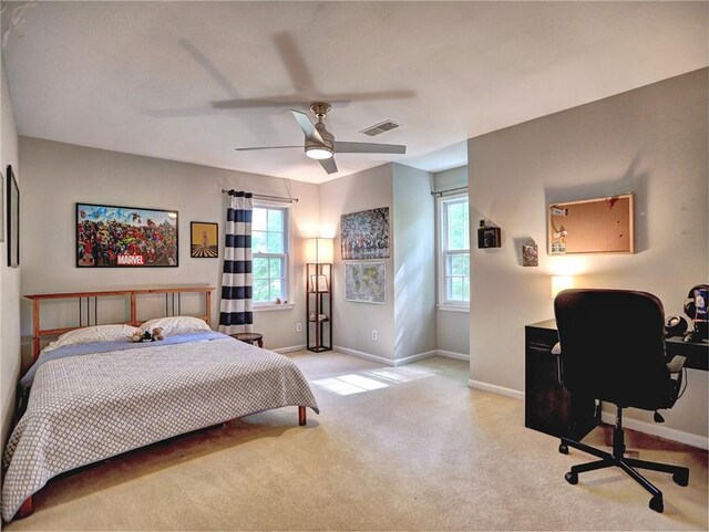 carpeted bedroom with baseboards, ceiling fan, and visible vents
