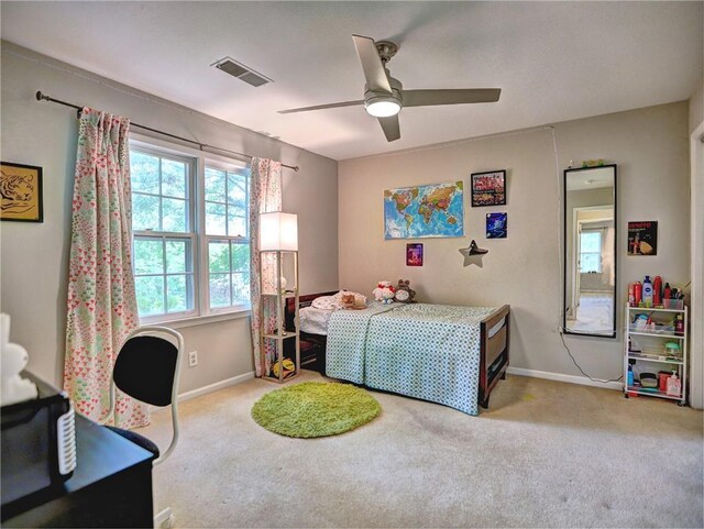 carpeted bedroom with a ceiling fan, baseboards, and visible vents