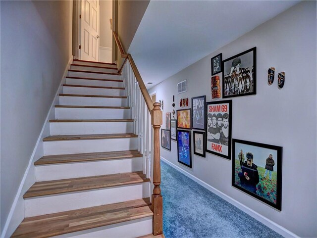 stairs featuring baseboards, visible vents, and carpet