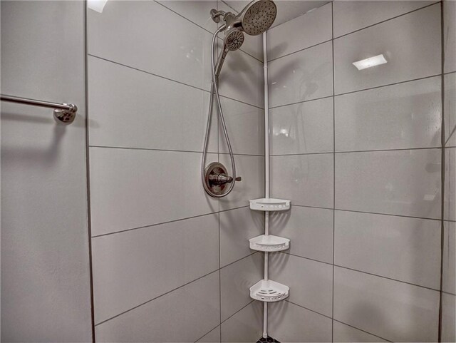 full bath with a tile shower