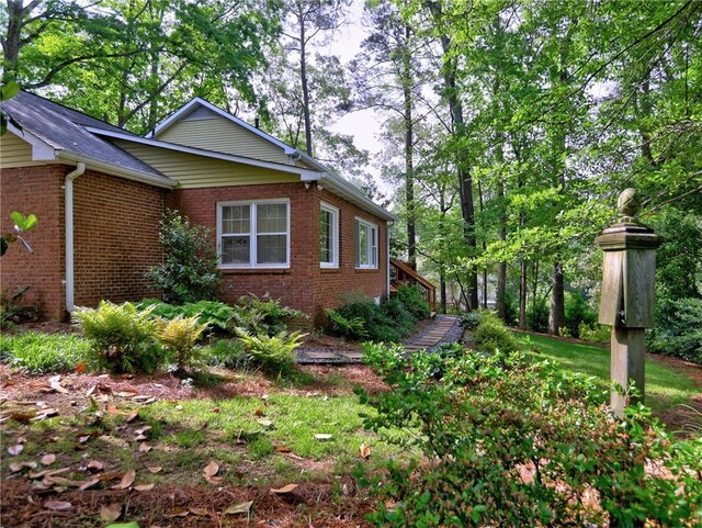 view of property exterior with brick siding