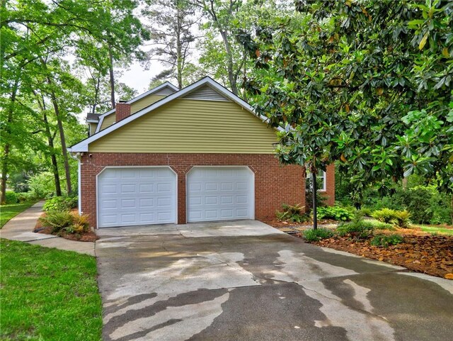 garage featuring concrete driveway