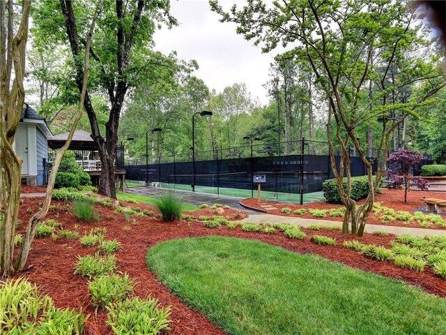 view of sport court featuring fence
