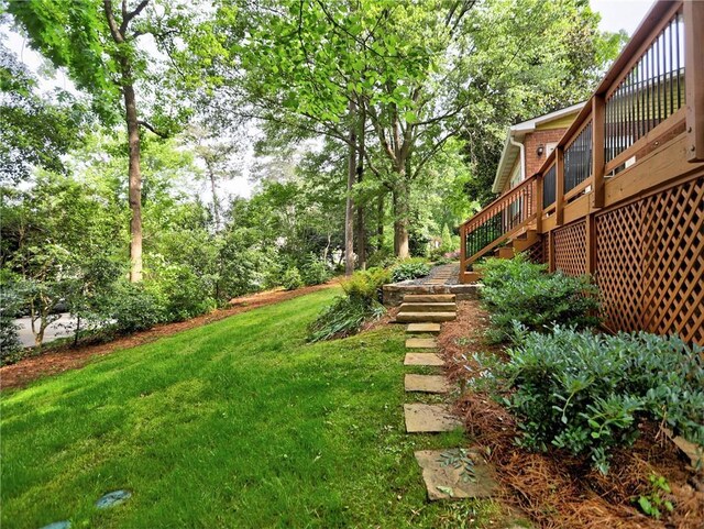 view of yard featuring a wooden deck and stairs