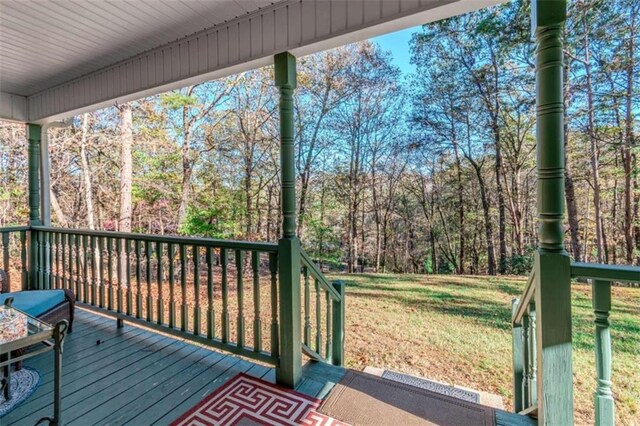 deck featuring a yard and a porch