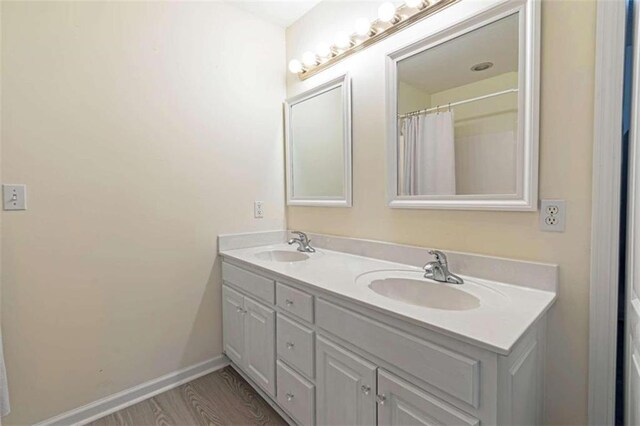 bathroom featuring vanity and wood-type flooring