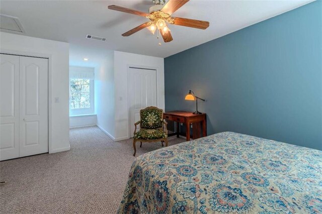 carpeted bedroom with ceiling fan and a closet