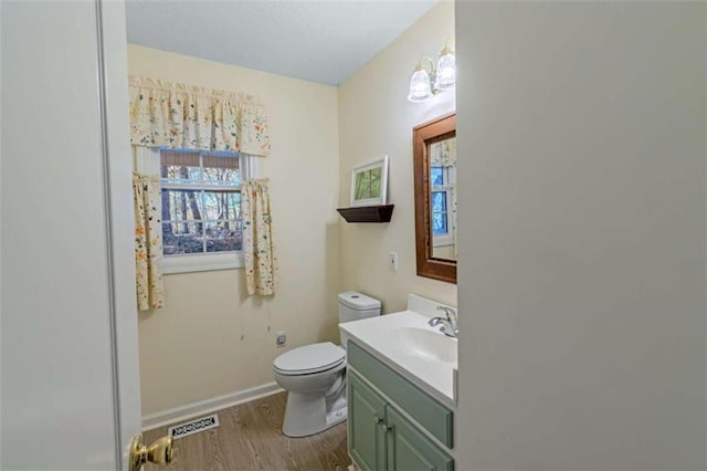 bathroom with vanity, toilet, wood-type flooring, and a chandelier