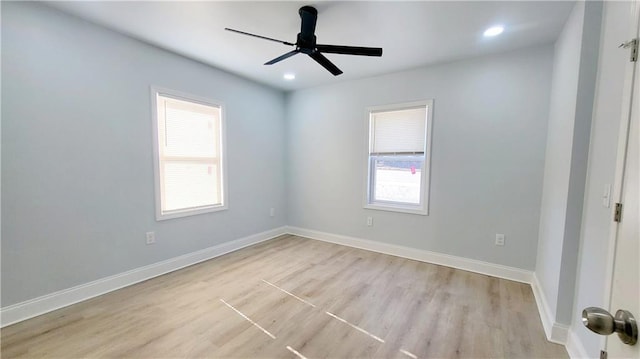 unfurnished room featuring ceiling fan, light hardwood / wood-style flooring, and a healthy amount of sunlight