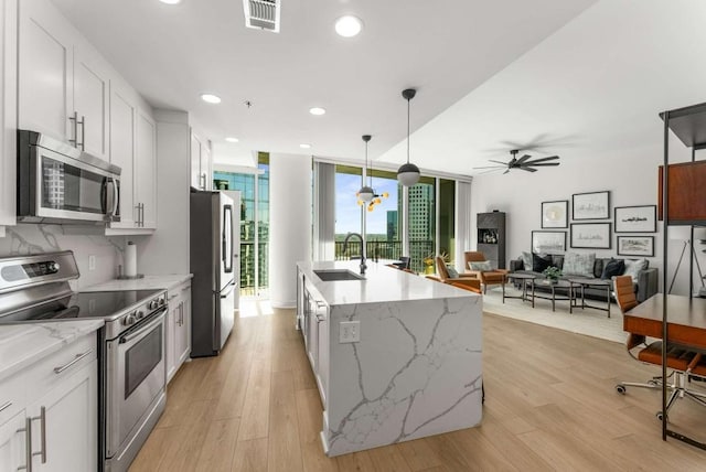 1080 Peachtree St NE Unit 1909, Atlanta, GA 30309 - kitchen featuring visible vents, a sink, expansive windows, stainless steel appliances, and ceiling fan