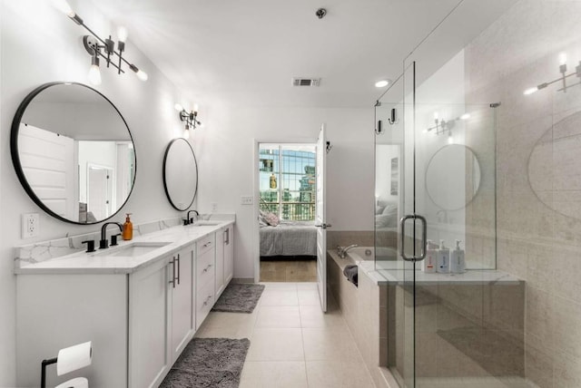 1080 Peachtree St NE Unit 1909, Atlanta, GA 30309 - ensuite bathroom featuring a sink, double vanity, a shower stall, and tile patterned floors