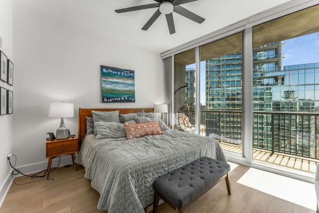 1080 Peachtree St NE Unit 1909, Atlanta, GA 30309 - bedroom with access to exterior, wood finished floors, baseboards, and expansive windows